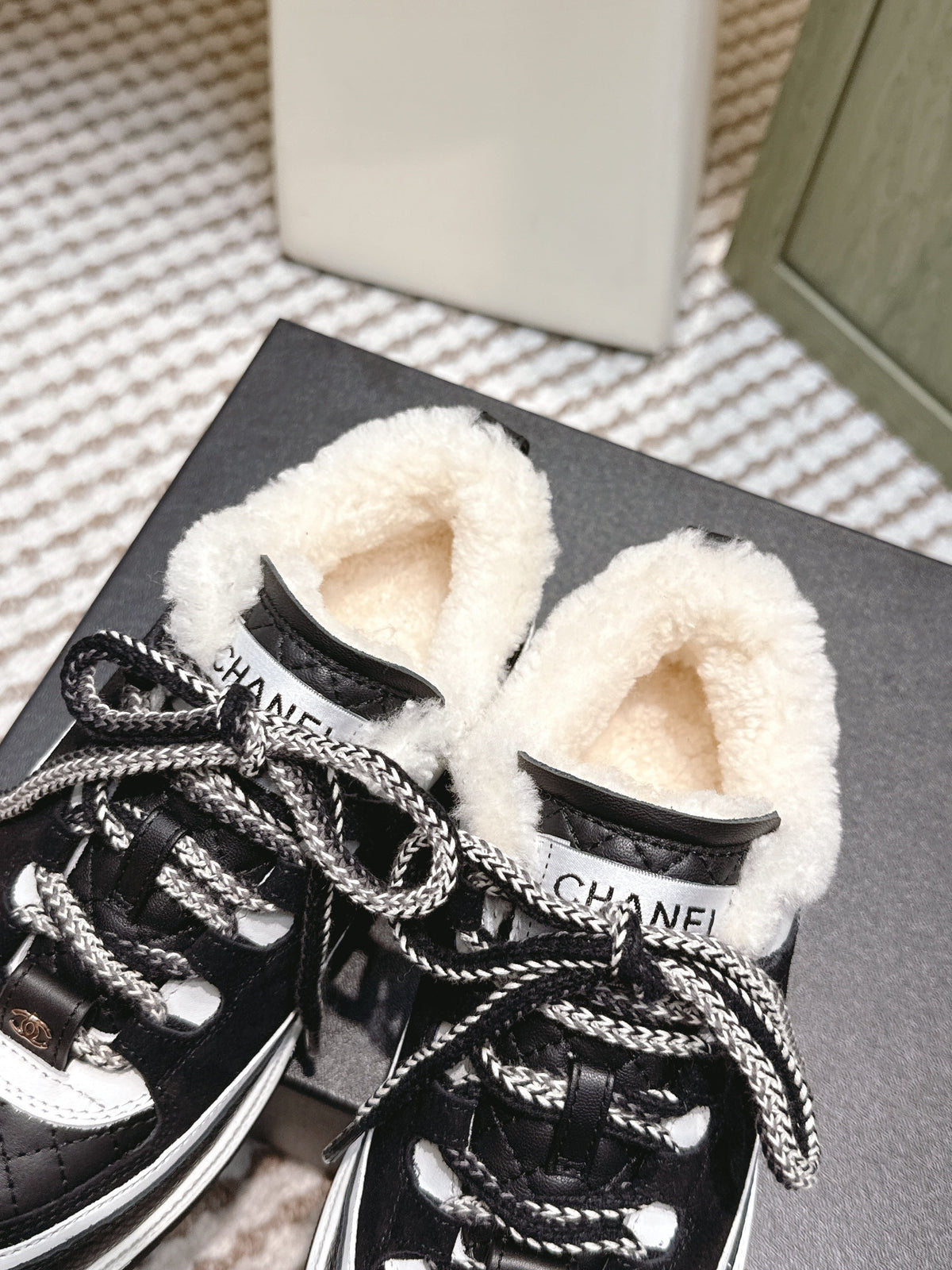 CHANEL 25S THICK-SOLE SNEAKERS IN BLACK AND WHITE CALFSKIN WITH FUR LINING